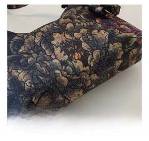 Close-up of Xiangyun silk crescent bag showing fabric texture and side stitching details