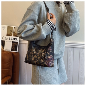 Detailed view of Xiangyun silk crescent bag with vintage floral patterns and adjustable strap