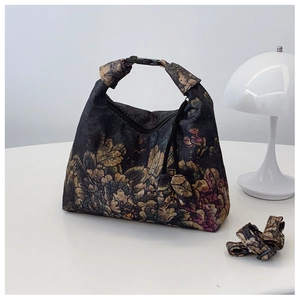 Close-up of Xiangyun Silk crescent bag with vintage floral patterns and adjustable strap