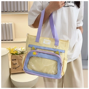 Detail view of the yellow and purple school tote bag featuring a clear PVC display window
