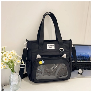 Detail of black ita bag with cat ears, transparent window, and FASHION BAG text