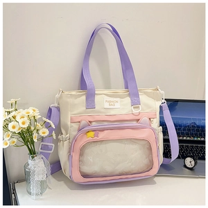 Detail of canvas tote bag featuring a transparent front window and cute cat ear design