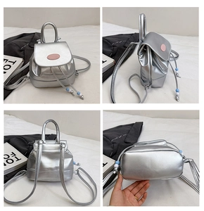Detail view of mini silver PU leather backpack featuring drawstring and beaded charms
