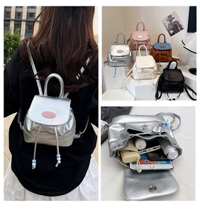 Internal storage view of mini bucket backpack holding tablet, umbrella, and essentials
