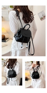 Detail of black faux leather mini backpack with drawstring and blue-white bead accents