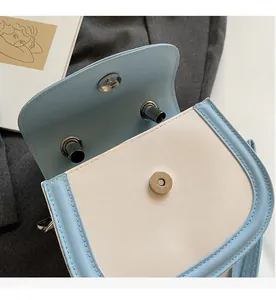 Close-up of secure magnetic closure and interior design on stylish patchwork crossbody bag