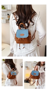 Detail of mini color-block backpack with blue denim flap and brown faux leather base