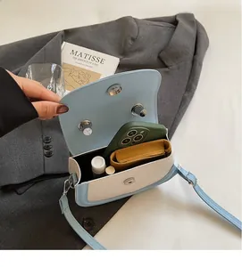 Internal view showing spacious capacity of the blue and white saddle crossbody bag