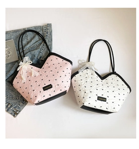 Detail of pink and white bucket bags with bow pattern and pearl lace charms