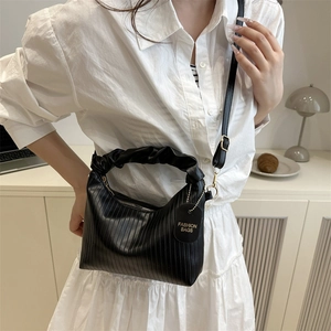 Fashionable black pleated handbag with ruffled handle and contrast shoulder strap