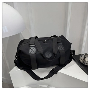 Close-up of durable black oxford travel bag with sturdy handles and adjustable shoulder strap
