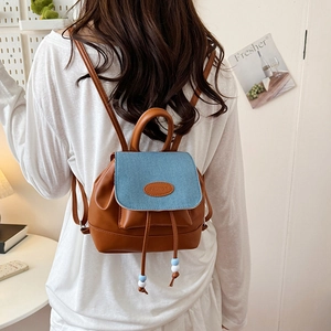 Vintage mini bucket backpack in brown leather and blue denim patchwork with drawstring