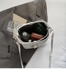Interior view of white leather drawstring bucket bag showing large storage capacity