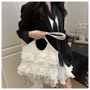 Detailed view of white layered lace tote bag with elegant ruffles and slim straps