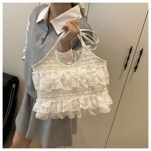 Detail view of a white multi-layer lace tote bag with tiered ruffles and sweet vintage style