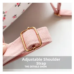 Close-up of adjustable pink shoulder strap and rose gold buckle on floral backpack