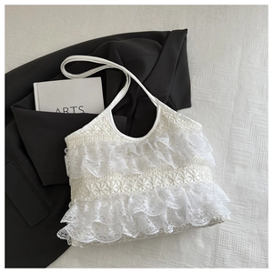 Close-up of white lace ruffle tote bag with woven texture and elegant French style details