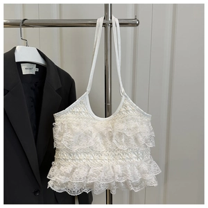 Detail of white lace multi-layer ruffle tote bag with floral hollow texture on shoulder strap