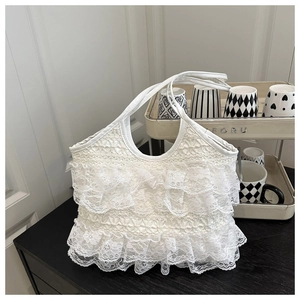 Detailed view of layered white lace ruffles and soft texture on a romantic tote bag