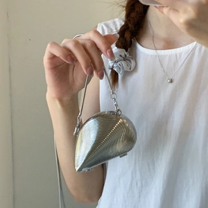 Silver shell-shaped evening clutch bag with textured metal finish and chain strap