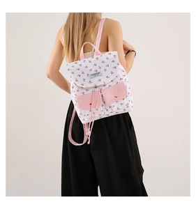 Floral backpack detail featuring pink drawstring closure and golden metal buckles