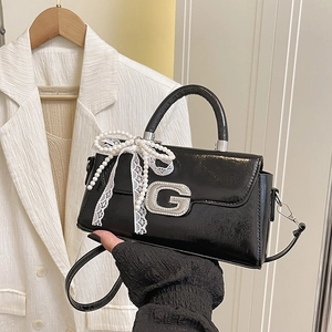 Chic black patent leather crossbody bag with metal G logo and pearl lace bow charm