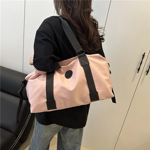 Pink waterproof large travel bag with adjustable strap and top handles for gym and travel