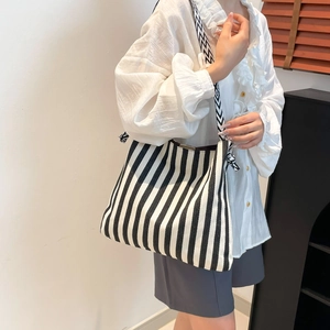 Minimalist black and white striped tote bag with geometric print wide shoulder strap