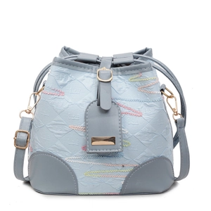 Chic light blue canvas bucket bag with colorful wavy embroidery and gray leather accents