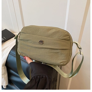 Olive green waterproof nylon crossbody bag with casual strap and metal logo