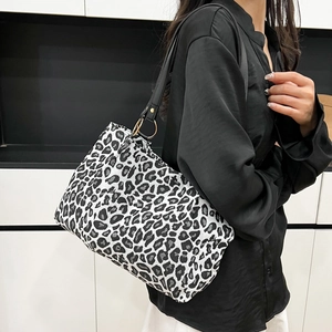 Fashionable leopard print canvas tote bag with black shoulder strap and gold hardware