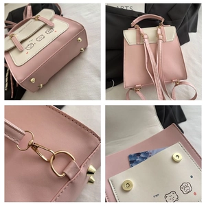 Detail view of pink and white contrast backpack featuring cute cartoon prints and card slot
