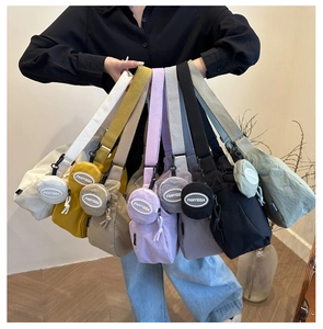 Nylon crossbody bag with round coin purse detail and adjustable strap in multiple colors