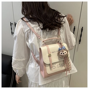 Rear view of a model wearing a pink and white leather backpack with cartoon bear print