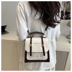 Detail of vintage beige and brown contrast backpack featuring three cute teddy bear icons