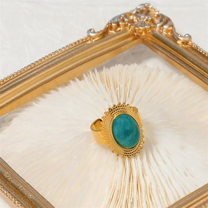 Vintage gold-plated stainless steel ring with green stone and sunburst open design