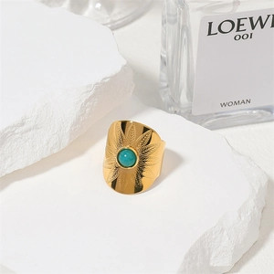 Golden stainless steel ring with turquoise stone and sunburst pattern on white stone