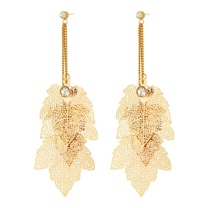 Macro detail of long gold leaf earrings featuring hollowed petals and sparkling rhinestones