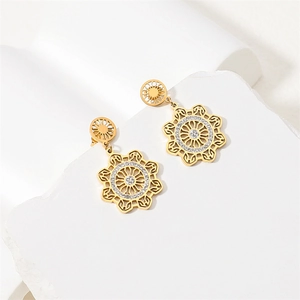 Elegant gold stainless steel leaf pendant earrings with white zircon on stone display