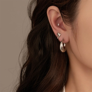Detail of G23 titanium flat back piercing set with dolphin stud and hoop earring