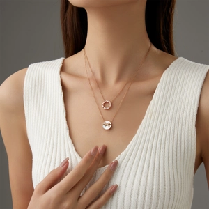 Double-layer rose gold necklace with shell flower pendant and pavé diamond cross design