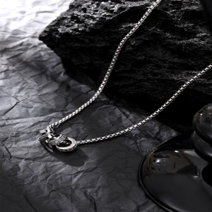 Silver interlocking rings pendant necklace with sparkling zircons on a sturdy box chain