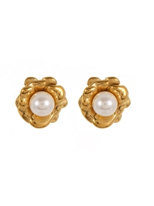 Detailed macro view of camellia flower earrings with gold petals and white pearls