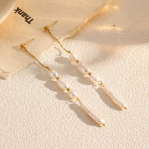 Elegant long pearl tassel earrings with baroque pearls and gold chain links