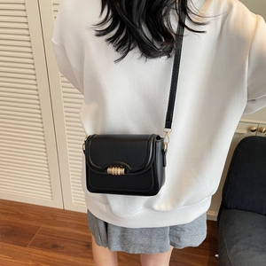 Classic black PU leather crossbody bag with gold metal buckle shown on model back view