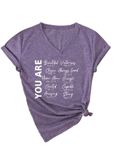 Détail du t-shirt violet à col en V avec texte blanc et revers aux manches