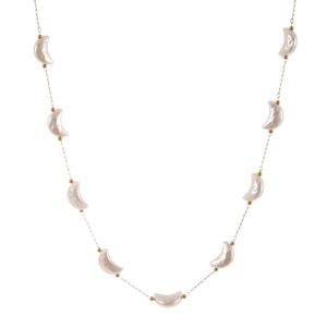Elegant gold necklace featuring nine crescent moon pearls on a delicate metal chain