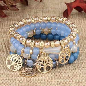 Bohemian multi-layer beaded bracelet set with Tree of Life charms on rustic burlap