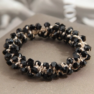 Elegant elastic hair tie with black faceted crystal beads and gold woven thread detail