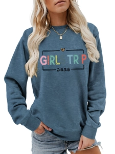 Detail of the blue sweatshirt with colorful Girl Trip 2026 text and leopard heart print